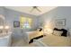 Bedroom with twin beds, light blue walls, and window with drapes at 275 Royal Oak Way, Venice, FL 34292
