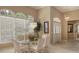 Bright dining room featuring glass table, wicker chairs, and large window at 275 Royal Oak Way, Venice, FL 34292