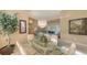 Spacious dining area with glass-top table, wicker chairs, and view into living room at 275 Royal Oak Way, Venice, FL 34292