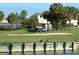 Golf course view with sand trap, golf cart, and waterfront at 275 Royal Oak Way, Venice, FL 34292