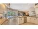 Kitchen boasts granite counters, stainless steel appliances, and pool view at 275 Royal Oak Way, Venice, FL 34292