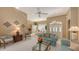 Bright living room with teal sofas and access to dining area at 275 Royal Oak Way, Venice, FL 34292