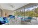 Covered patio with wicker furniture and pool view at 275 Royal Oak Way, Venice, FL 34292