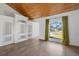 Living room with wood ceilings, large window, and tile floors at 2972 Crane Ave, North Port, FL 34286