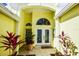 Welcoming entryway with etched glass double doors, potted plants, and tiled flooring at 340 Bermuda Ct # 5, Venice, FL 34293