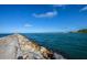 Scenic view of a stone jetty extending into the ocean under a clear blue sky at 340 Bermuda Ct # 5, Venice, FL 34293