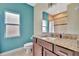 Bathroom with teal walls and granite vanity, reflecting a clean aesthetic at 3436 Santa Clara Dr, Punta Gorda, FL 33983