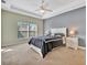 Relaxing bedroom with neutral decor, large window, and ceiling fan at 3436 Santa Clara Dr, Punta Gorda, FL 33983