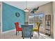 Bright breakfast nook with glass table and colorful chairs, adjacent to a teal accent wall at 3436 Santa Clara Dr, Punta Gorda, FL 33983