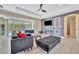 Bright living room with sectional sofa, ottoman, and view of pool at 3436 Santa Clara Dr, Punta Gorda, FL 33983