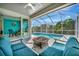 Screened lanai with pool, seating, and fire pit at 3436 Santa Clara Dr, Punta Gorda, FL 33983