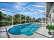 Refreshing screened pool overlooking lush greenery and waterway at 3436 Santa Clara Dr, Punta Gorda, FL 33983