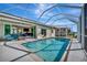 Relaxing screened pool area with view of canal and neighboring home at 3436 Santa Clara Dr, Punta Gorda, FL 33983