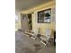 Front porch with two white folding chairs and open door at 347 Longwood Dr, Venice, FL 34285