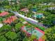 Community overview showcasing homes, tennis court, and pool at 3667 Yellow Pine Ct # 149, Sarasota, FL 34238