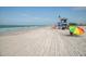 Lifeguard station and beachgoers on a white sand beach at 3667 Yellow Pine Ct # 149, Sarasota, FL 34238