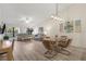 Open concept dining room with glass table and modern light fixture at 3667 Yellow Pine Ct # 149, Sarasota, FL 34238