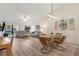Open concept dining room with glass table and modern light fixture at 3667 Yellow Pine Ct # 149, Sarasota, FL 34238