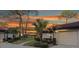 Exterior view of condo with landscaped grounds and a sunset at 3667 Yellow Pine Ct # 149, Sarasota, FL 34238