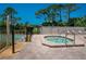 Community hot tub with surrounding patio and lounge chairs at 3667 Yellow Pine Ct # 149, Sarasota, FL 34238