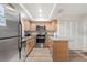 Modern kitchen featuring stainless steel appliances and light wood cabinets at 3667 Yellow Pine Ct # 149, Sarasota, FL 34238
