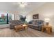 Living Room with grey couches, wood flooring, and large windows at 3667 Yellow Pine Ct # 149, Sarasota, FL 34238