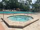 Community pool and spa with ample deck space for lounging at 3667 Yellow Pine Ct # 149, Sarasota, FL 34238