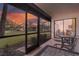 Spacious screened patio with access to living room, featuring sunset views at 3667 Yellow Pine Ct # 149, Sarasota, FL 34238