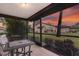 Relaxing screened patio with table and chairs, offering scenic sunset views at 3667 Yellow Pine Ct # 149, Sarasota, FL 34238