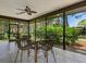 Relaxing screened porch with wicker furniture and view of nature at 3667 Yellow Pine Ct # 149, Sarasota, FL 34238