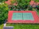 Community tennis court with red and green surface and ample surrounding space at 3667 Yellow Pine Ct # 149, Sarasota, FL 34238