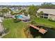 Community pool, dock, and surrounding buildings from above at 380 Three Lakes Ln # E, Venice, FL 34285