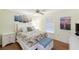 Bright and airy bedroom with white furniture and floral bedding at 380 Three Lakes Ln # E, Venice, FL 34285