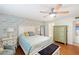 Main bedroom with wooden flooring, patterned bedding, nightstands, and a dresser at 380 Three Lakes Ln # E, Venice, FL 34285