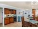 Dining area next to the kitchen, featuring wood cabinets, a wine cooler, and dry bar at 380 Three Lakes Ln # E, Venice, FL 34285