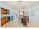 Dining area adjacent to the kitchen, with a glass-top table and seating for four at 380 Three Lakes Ln # E, Venice, FL 34285