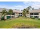 Condominium buildings surrounded by palm trees and green lawns at 380 Three Lakes Ln # E, Venice, FL 34285