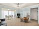 Living area with a couch, recliner, TV, and view of dining area with sliding glass doors to the patio at 380 Three Lakes Ln # E, Venice, FL 34285