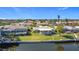 Aerial view of waterfront homes with lush landscaping and private docks at 4 Windsor Dr, Englewood, FL 34223