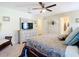 Comfortable bedroom featuring a ceiling fan, wooden floors, and a decorative dresser and mirror at 4 Windsor Dr, Englewood, FL 34223