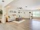 Open-concept living area featuring hardwood floors and neutral decor at 4 Windsor Dr, Englewood, FL 34223