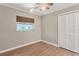 Bedroom with closet, wood-look flooring, ceiling fan, and neutral walls at 409 Manatee Ct # 112, Venice, FL 34285