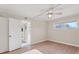 Bedroom featuring wood-style flooring, neutral walls, a ceiling fan, and access to an ensuite bathroom at 409 Manatee Ct # 112, Venice, FL 34285