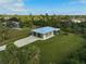 Aerial view of single-story home with two-car garage and spacious yard at 4130 Rock Creek Dr, Port Charlotte, FL 33948
