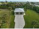 Two-car garage with a large driveway and lush green lawn at 4130 Rock Creek Dr, Port Charlotte, FL 33948