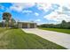 Two-car garage with metal roof and large concrete driveway at 4130 Rock Creek Dr, Port Charlotte, FL 33948