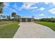 Two-car garage with metal roof and concrete driveway at 4130 Rock Creek Dr, Port Charlotte, FL 33948