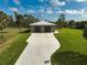 Detached two-car garage, spacious driveway, and a beautifully landscaped yard at 4130 Rock Creek Dr, Port Charlotte, FL 33948