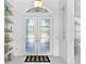 Bright foyer with etched glass double doors, tile floor, and display shelves at 4151 Natale Dr, Venice, FL 34293