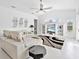 Living room with white sectional sofa, decorative rug, and built-in entertainment center at 4151 Natale Dr, Venice, FL 34293